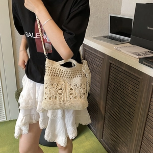 Elegant beige crochet crossbody bag with floral hollow-out pattern and sweet bow details