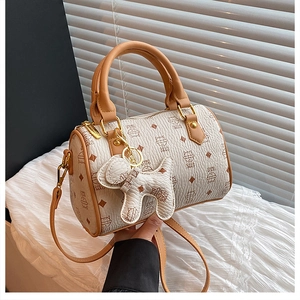 Detail of Boston bag with cat print and matching cartoon dog charm accessory