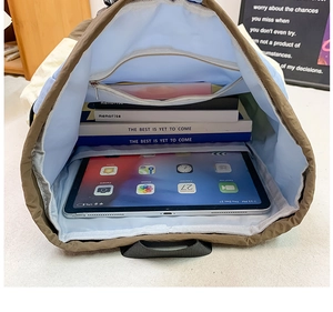 Detail view of large capacity kids backpack interior with iPad compartment and zipper pocket