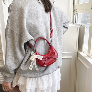 Sweet red crescent shoulder bag with a bow detail and elegant pearl lace pendant