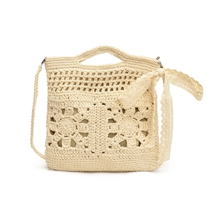 Floral crochet crossbody bag with hollow patterns and a cream bow decoration