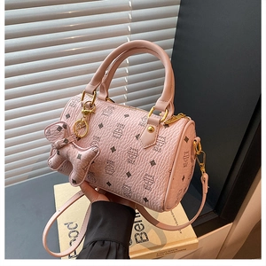 Detailed view of pink Boston bag featuring cute cat prints and a puppy shape leather charm