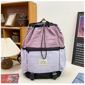 Detail of color-block purple school bag featuring waterproof fabric and drawstring closure