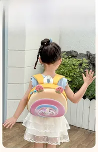 Rear view of a girl wearing a cartoon rainbow snail backpack with soft padded straps