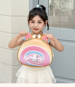 Detail of cute cake roll style backpack for kids with 3D strawberry and rabbit accents