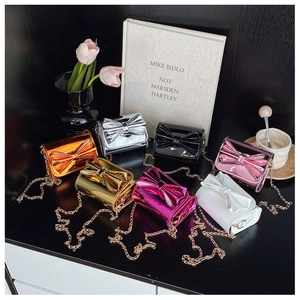 Group of colorful bow-knot crossbody bags with glossy mirror finish and gold chains