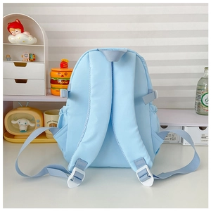 Detail view of light blue backpack featuring padded S-shape straps and side mesh pockets