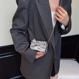 Silver metallic mini crossbody bag with large bow and gold chain strap for girls
