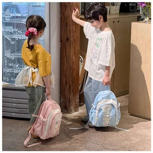 Kids star pattern backpack shown by boy and girl models in pink and light blue styles