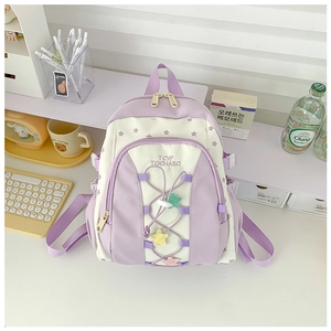 Detail of cute purple star backpack with crisscross cords and colorful star charms