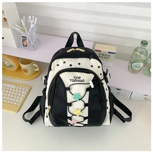 Detail of cute star pattern and TCYP TOCHASO text on black and white kids backpack