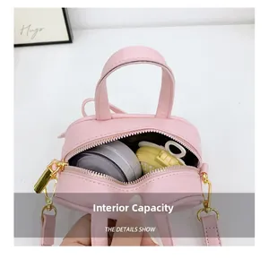 Pink mini PU leather handbag interior view showing storage capacity and smooth zipper