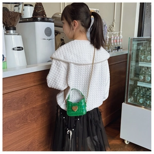 Girl's bright green crocodile pattern mini crossbody bag with golden heart clasp