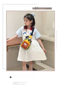Detail of colorful patchwork kids crossbody bag with orange pocket and adjustable strap