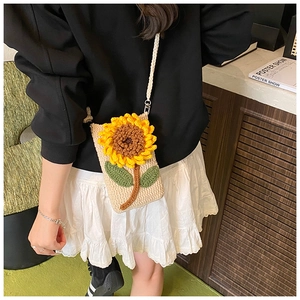 Détail du sac de téléphone tournesol crocheté à la main, porté par un mannequin en intérieur