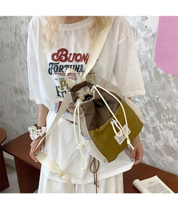 Dettaglio dello zaino color-block con chiusura a coulisse e tasche laterali a rete