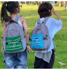 Detail of outdoor school backpack showing side mesh pockets and colorful bungee cords