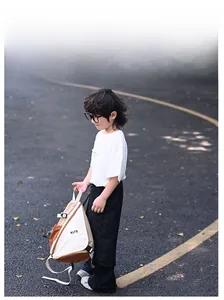 Detail of multi-color canvas crossbody bag for kids with adjustable white strap