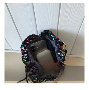 Close-up of sequin bucket bag interior showing spacious capacity for phone and accessories