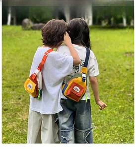 Outdoor view of kids color-block crossbody chest bag with adjustable strap and buckles