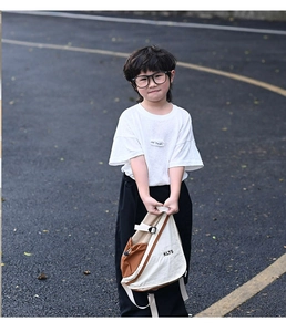 Detail of a beige and brown color-block kids' chest bag featuring KLTS lettering print