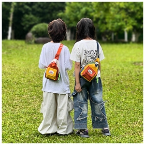Detail of adjustable buckle straps and canvas pockets on colorful kids chest bags