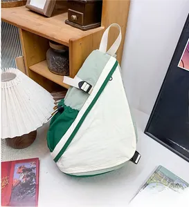 Detailed close-up of color-block nylon kids chest bag with KLTS lettering and buckle