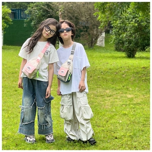 Outdoor close-up of kids color-block crossbody chest bags with adjustable wide straps