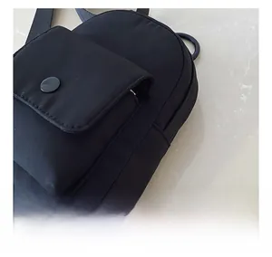 Close-up of durable black nylon fabric texture and flap pocket with snap button detail