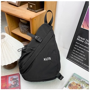Detail showing black nylon chest bag with white KLTS logo and adjustable strap buckles