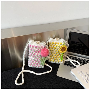 Detail of handmade crochet shoulder bags with floral tulip and sunflower 3D patterns
