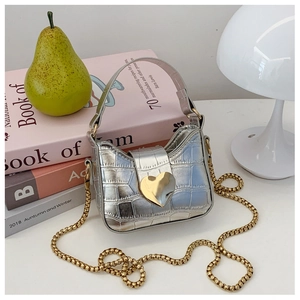 Silver crocodile texture mini bag featuring a large golden heart clasp and chain strap