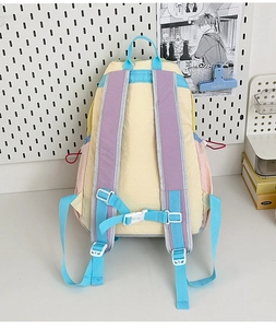 Detail view of adjustable padded purple straps and blue chest buckle on school backpack