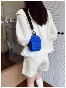 Blue mini nylon chest bag for kids with adjustable strap and small front pocket