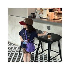 Detailed side view of a purple nylon crossbody bag for children with adjustable strap