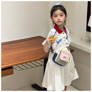 Detail of colorful patchwork kids chest bag with adjustable strap and DOUDING logo