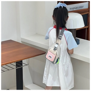 Detail view of the colorful kids chest bag showing the adjustable strap and buckle closure