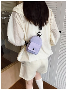 Mini lavender nylon crossbody chest bag with adjustable strap worn by child model