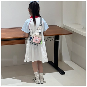Detail view of colorful kids crossbody chest bag with adjustable strap and mountain patch