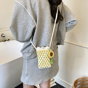 Handmade crochet shoulder bag with floral tulip patterns and sunflower charm accessory