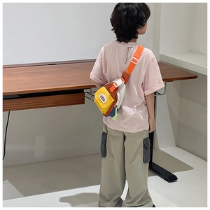 Close-up of kids crossbody chest bag with adjustable strap and colorful outdoor design