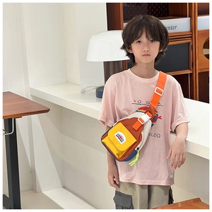 Detail view of colorful kids chest bag showing adjustable strap and buckle on model