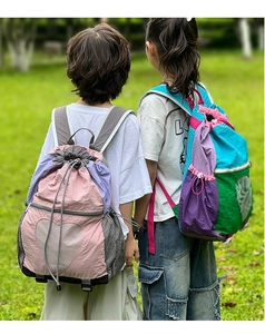 Detailed back view of children's colorful nylon drawstring backpacks with heart mesh design