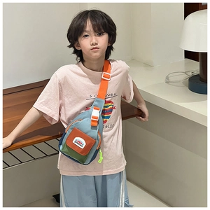 Detail of colorful canvas kids chest bag with orange strap and vibrant color-block design