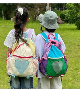 Outdoor shot of kids colorful drawstring backpack with heart-shaped mesh pocket detail