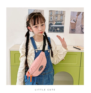 Pink kids chest bag with SPORT logo shown on a small model in a warm room setting