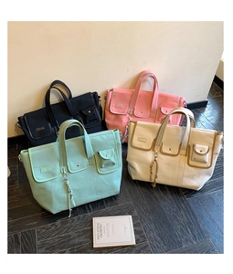 Detailed display of four large canvas tote bags in black, pink, green and beige colors