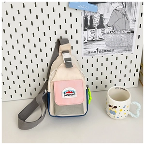 Close-up of contrast color kids chest bag with adjustable strap and mountain pattern