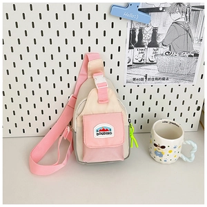 Detail of pink and beige canvas kids crossbody bag with DOUDING embroidery and clip buckle