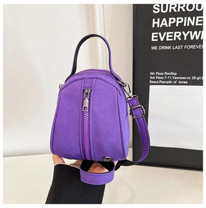 Detailed macro view of the durable purple nylon fabric and silver zipper of this mini bag